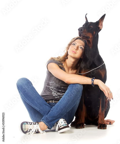 Photo: Young woman with black dobermann dog Young woman with black dobermann dog