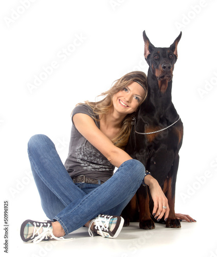 Photo: Young woman with black dobermann dog Young woman with black dobermann dog