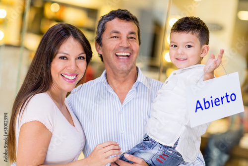 Photo: Family holding an open sign Family holding an open sign