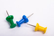 three thumbtacks on a white background