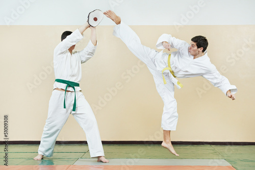 Photo: Two man at taekwondo exercises Two man at taekwondo exercises