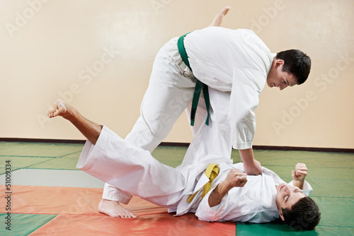 Photo: Two man at taekwondo exercises Two man at taekwondo exercises