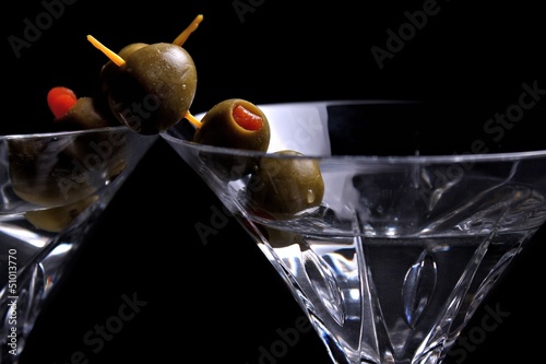 Photo: Two martinis on black with olives Two martinis on black with olives