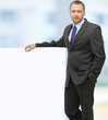 Handsome Businessman holding a blank sign in front of him