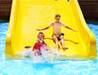 Children on water slide at aquapark.
