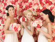 three women with background full of roses