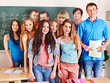 Group student near blackboard.