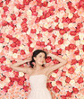 young woman with background full of roses