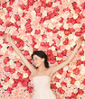 young woman with background full of roses