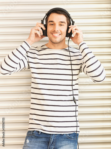 Photo: man in casual clothes with headphones man in casual clothes with headphones