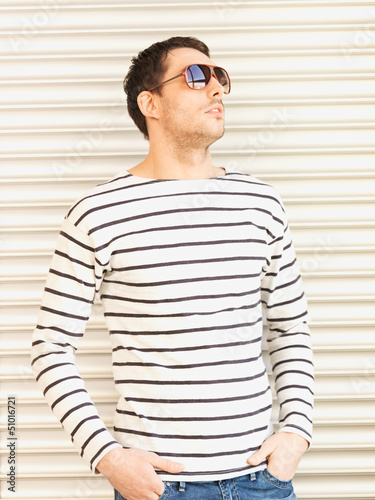 Photo: handsome man in casual clothes wearing sunglasses handsome man in casual clothes wearing sunglasses