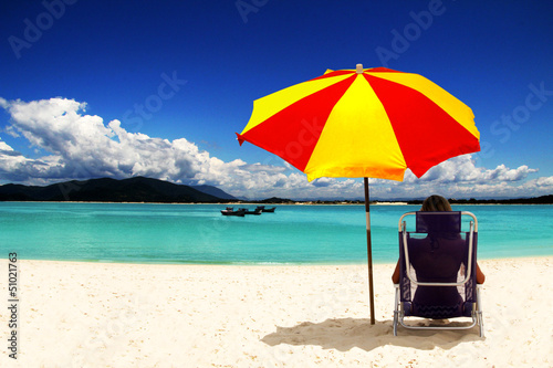 Photo: Woman with sun umbrella on the beach Woman with sun umbrella on the beach