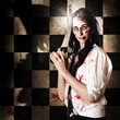 Photo: Gruesome evil zombie holding bloody saw Gruesome evil zombie holding bloody saw