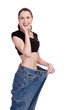 Photo: Surprised girl in big jeans. White background Surprised girl in big jeans. White background