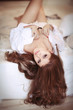 Brunette woman in bed in mornimg