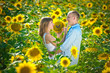 Photo: loving young couple in a field of sunflowers loving young couple in a field of sunflowers