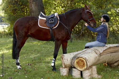 Photo: Horse and rider taking a break in the woods Horse and rider taking a break in the woods