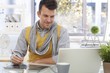 Young designer using drawing pad smiling