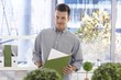 Portrait of casual office worker with folder