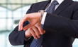 Businessman checking time on his wristwatch.