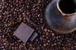 coffee beans, pieces of dark chocolate and Cezve