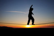 silhouette of slackliner in sunset
