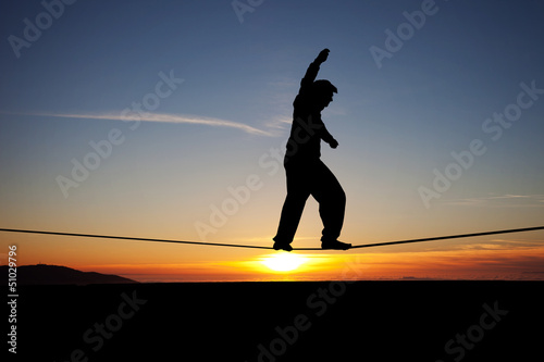 Photo: silhouette of slackliner in sunset silhouette of slackliner in sunset