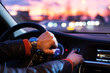 Man driving his modern car at night in a city