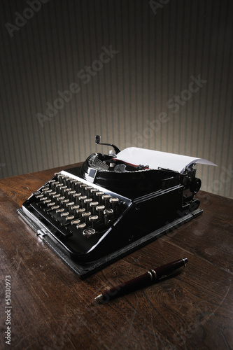 Photo: Old typewriter on a wooden desk Old typewriter on a wooden desk