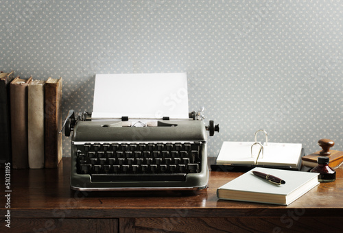 Photo: Old typewriter on a wooden desk Old typewriter on a wooden desk