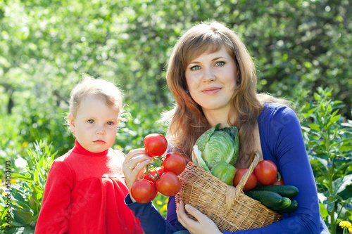 Photo: woman and baby with vegetables harvest woman and baby with vegetables harvest