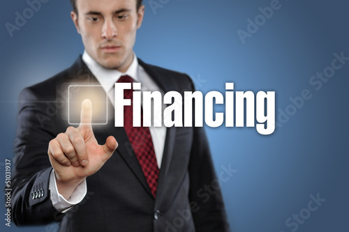 Photo: Man touching display Financing Man touching display Financing