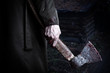 Axe with blood in male hand