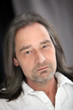 Serious unshaven man with long hair