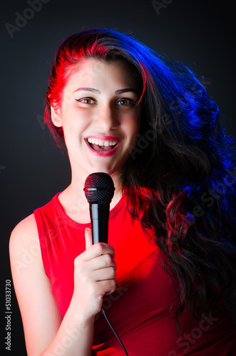 Photo: Female performer at disco with mic Female performer at disco with mic