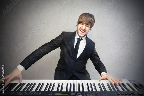 Photo: man playing pianoforte man playing pianoforte