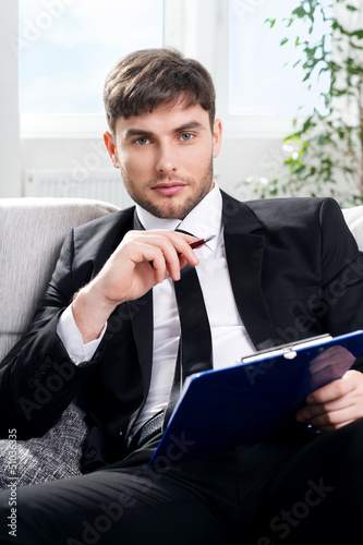 Photo: male psychologist being ready to take notes male psychologist being ready to take notes