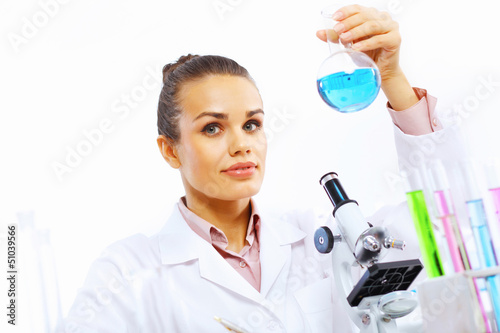 Photo: Young female scientist working in laboratory Young female scientist working in laboratory