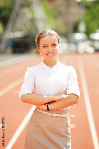 Photo: Business woman sport manager at athletic stadium Business woman sport manager at athletic stadium