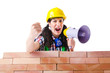 Woman with louspeaker near brick wall