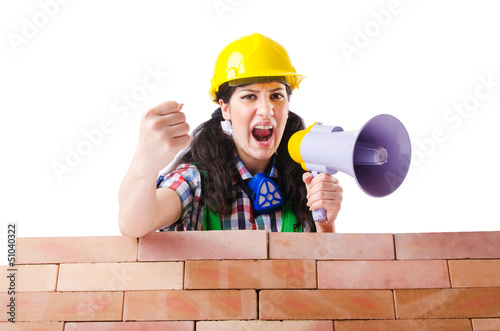 Photo: Woman with louspeaker near brick wall Woman with louspeaker near brick wall