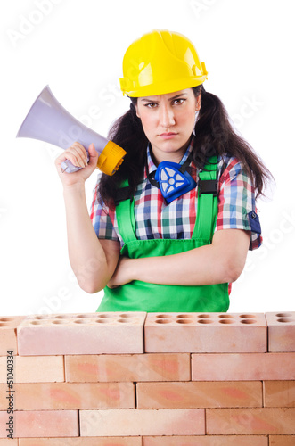 Photo: Woman with louspeaker near brick wall Woman with louspeaker near brick wall
