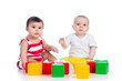 two babies or kids playing together with color toys