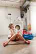 housewife in the laundry smokes and reads a book