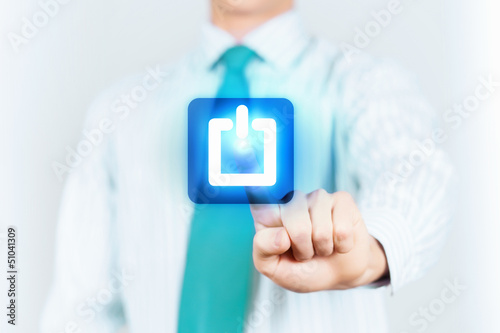 Photo: Young man press the power button Young man press the power button