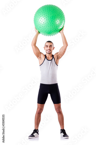 Photo: Man with swiss ball doing exercises on white Man with swiss ball doing exercises on white
