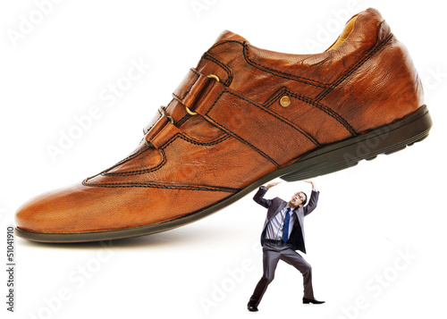 Photo: Woman domination concept with shoes and man Woman domination concept with shoes and man