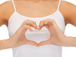 woman's hands showing heart shape