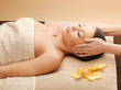 woman in spa salon lying on the massage desk
