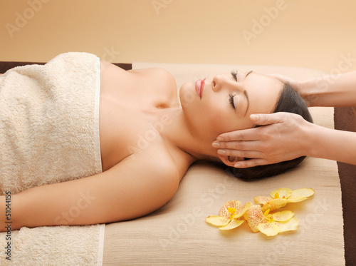 Photo: woman in spa salon lying on the massage desk woman in spa salon lying on the massage desk